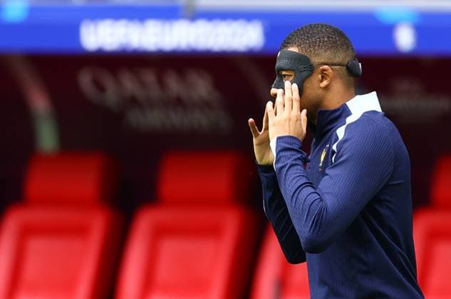 Kylian Mbappe of France puts on his face mask to protect his broken nose during warm up France v Belgium, UEFA European Championship, EM, Europameisterschaft 2024, Round of 16, Football, Dusseldorf Arena, Dusseldorf, Germany - 01 Jul 2024 EDITORIAL USE ONLY No use with unauthorised audio, video, data, fixture lists, club league logos or live services. Online in-match use limited to 120 images, no video emulation. No use in betting, games or single club league player publications.  Copyright: xKieranxMcManus Shutterstockx 14566634t