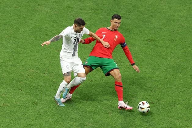 Cristiano Ronaldo of Portugal and Petar Stojanovic of Slovenia Portugal v Slovenia, UEFA European Championship, EM, Europameisterschaft 2024, Round of 16, Football, Frankfurt Arena, Frankfurt, Germany - 01 Jul 2024 EDITORIAL USE ONLY No use with unauthorised audio, video, data, fixture lists, club league logos or live services. Online in-match use limited to 120 images, no video emulation. No use in betting, games or single club league player publications.  Copyright: xPaulxCurrie Shutterstockx 14566636ad