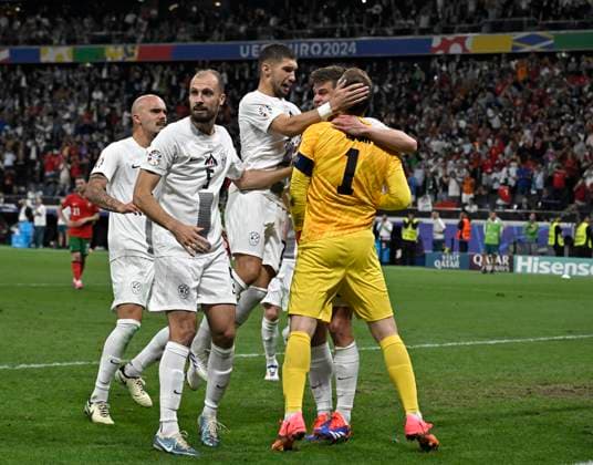 01.07.2024, Fussball UEFA EURO, EM, Europameisterschaft,Fussball 2024, Achtelfinale, Portugal - Slowenien, in der Frankfurt Arena Frankfurt am Main, Jon Gorenc Stankovic (Slowenien) feiert den Keeper Jan Oblak (Slowenien) sowie auch die anderen Spieler.