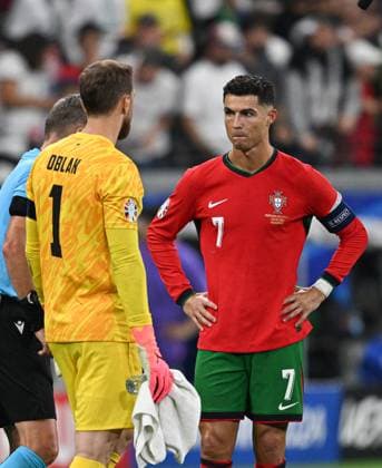 (240702) -- FRANKFURT, July 2, 2024 -- Cristiano Ronaldo (R) of Portugal and Slovenia s goalkeeper Jan Oblak react before the penalty shootout during the UEFA EURO, EM, Europameisterschaft,Fussball 2024 Round of 16 match between Portugal and Slovenia in Frankfurt, Germany on July 1, 2024. ) (SP)GERMANY-FRANKFURT-FOOTBALL-EURO 2024-PORTUGAL VS SLOVENIA RenxPengfei 