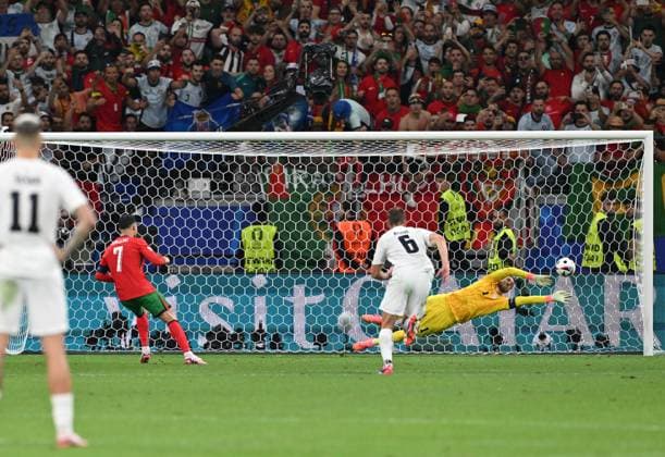 (240702) -- FRANKFURT, July 2, 2024 -- Slovenia s goalkeeper Jan Oblak (R) saves the penalty kick by Cristiano Ronaldo of Portugal during the UEFA EURO, EM, Europameisterschaft,Fussball 2024 Round of 16 match between Portugal and Slovenia in Frankfurt, Germany on July 1, 2024. ) (SP)GERMANY-FRANKFURT-FOOTBALL-EURO 2024-PORTUGAL VS SLOVENIA RenxPengfei 