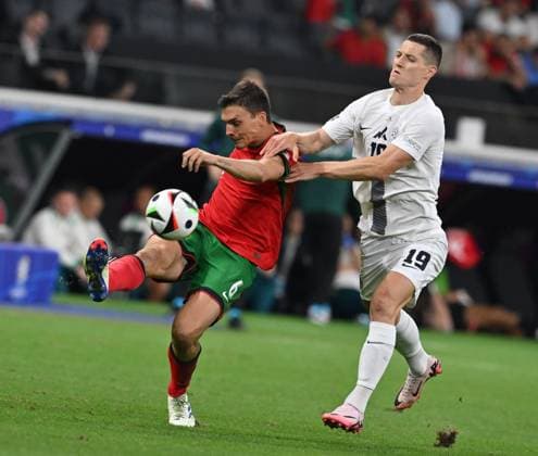 (240702) -- FRANKFURT, July 2, 2024 -- Joao Palhinha (L) of Portugal vies with Zan Celar of Slovenia during the UEFA EURO, EM, Europameisterschaft,Fussball 2024 Round of 16 match between Portugal and Slovenia in Frankfurt, Germany on July 1, 2024. ) (SP)GERMANY-FRANKFURT-FOOTBALL-EURO 2024-PORTUGAL VS SLOVENIA RenxPengfei 