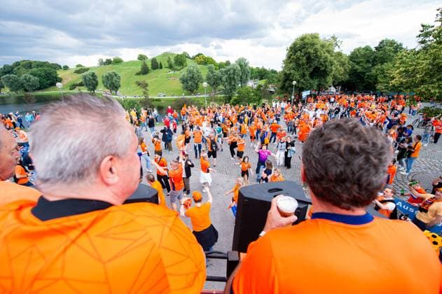 02.07.2024 - Fußball, Europameisterschaft 2024 in Deutschland, Fans in München Rumänien - Niederlande: Niederländische Fans vor dem Fanbus vor dem Spiel beim Fanmarsch mit Blick auf den Olympiaberg.