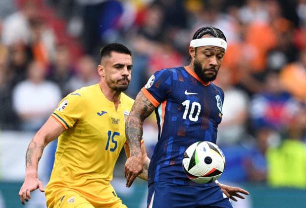 Germany Soccer Euro 2024 Romania - Netherlands 8721255 02.07.2024 Romania s Andrei Burca, left, and Netherlands Memphis Depay struggle for a ball during the UEFA EURO, EM, Europameisterschaft,Fussball 2024 round of 16 soccer match between Romania and Netherlands at the Munich Football Arena in Munich, Germany. Alexey Filippov Sputnik Munich Germany  Copyright: xAlexeyxFilippovx