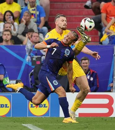 02.07..2024, Fussball Europameisterschaft, Holland vs Rumaenien, Munich Football Arena, im Bild: Radu Dragusin (Rumaenien) vs Xavi (Holland)