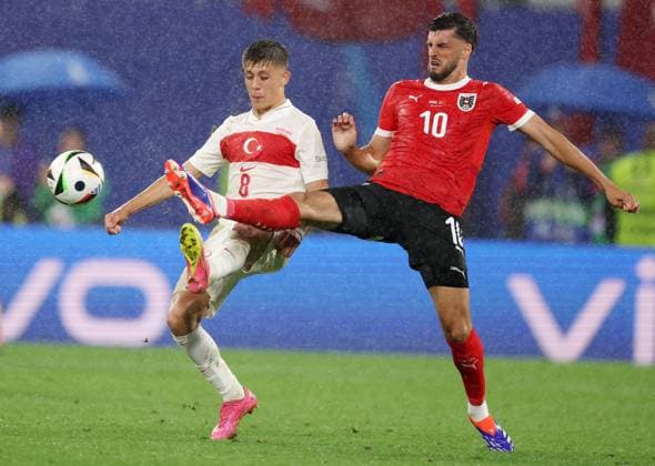 Leipzig, Germany, 2nd July 2024. Arda Guler of Turkey (L) is challenged by Florian Grillitsch of Austria during the UEFA European Championships Round of 16 match at Leipzig Stadium, Leipzig. Picture credit should read: Paul Terry Sportimage EDITORIAL USE ONLY. No use with unauthorised audio, video, data, fixture lists, club league logos or live services. Online in-match use limited to 120 images, no video emulation. No use in betting, games or single club league player publications. SPI-3215-0067