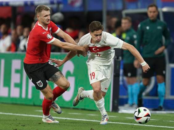 Football - 2024 UEFA European Championships Finals - Round of Sixteen - Austria vs Turkey - Leipzig Stadium - Tuesday 2nd July 2024 Kenan Y?ld?z of Turkey vies with Stefan Posch of Austria 