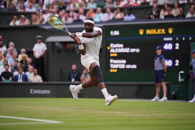 LONDON, ENGLAND - JULY 05: Frances Tiafoe of United States plays a backhand against Carlos Alcaraz of Spain in his Gentlemen s Singles third round match during day five of The Championships Wimbledon 2024 at All England Lawn Tennis and Croquet Club on July 05, 2024 in London, England  Copyright: xHiroshixSatox