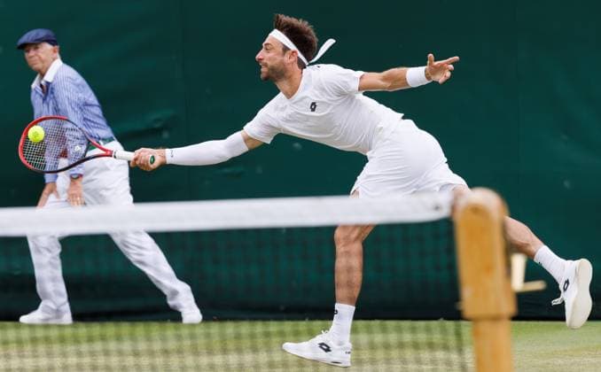 Belgian Sander Gille pictured in action during a doubles tennis match between Belgian pair Gille-Vliegen and Argentinian pair Etcheverry-Cerundolo, in the first round of the men s doubles competition of the 2024 Wimbledon grand slam tournament at the All England Tennis Club, in south-west London, Britain, Friday 05 July 2024. BENOITxDOPPAGNE  x95888332x