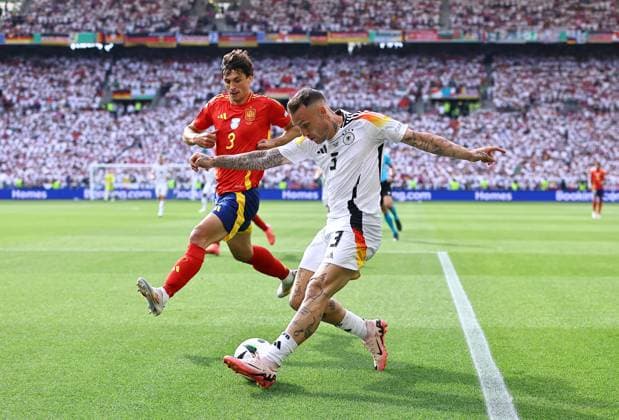 David Raum of Germany crosses the ball whilst under pressure from Robin Le Normand of Spain Spain v Germany, UEFA European Championship, EM, Europameisterschaft 2024, Quarter Final, Football, Stuttgart Arena, Stuttgart, Germany, 05 Jul 2024 EDITORIAL USE ONLY No use with unauthorised audio, video, data, fixture lists, club league logos or live services. Online in-match use limited to 120 images, no video emulation. No use in betting, games or single club league player publications. Copyright: xMichaelxZemanek Shutterstockx 14571380as