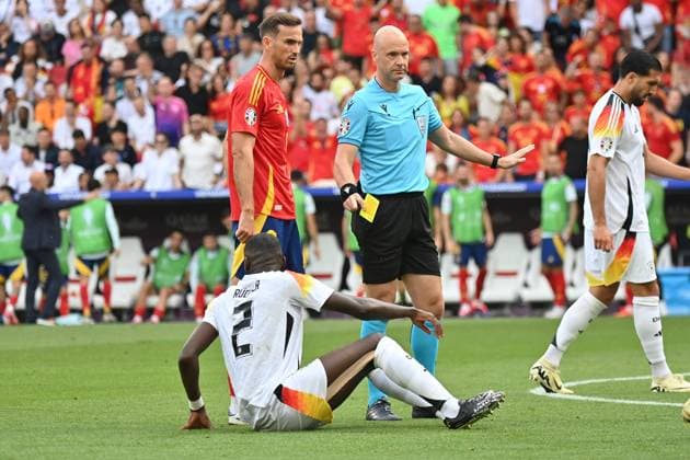 05.07.2024, xjrdrx, Fussball EM 2024 1 4 Finale, Deutschland - Spanien emspor, v.l. Schiedsrichter Referee Anthony Taylor (England) zeigt Antonio Rüdiger (Deutsche Fussball Nationalmannschaft DFB) die gelbe Karte (DFL DFB REGULATIONS PROHIBIT ANY USE OF PHOTOGRAPHS as IMAGE SEQUENCES and or QUASI-VIDEO) Stuttgart