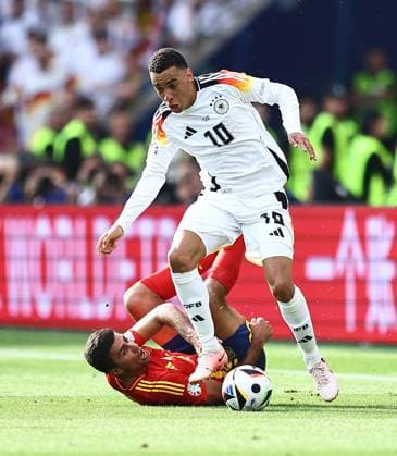Rodri of Spain challenges Jamal Musiala of Germany Spain v Germany, UEFA European Championship, EM, Europameisterschaft 2024, Quarter Final, Football, Stuttgart Arena, Stuttgart, Germany, 05 Jul 2024 EDITORIAL USE ONLY No use with unauthorised audio, video, data, fixture lists, club league logos or live services. Online in-match use limited to 120 images, no video emulation. No use in betting, games or single club league player publications.  Copyright: xMichaelxZemanek Shutterstockx 14571380bg