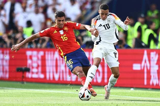 Rodri of Spain challenges Jamal Musiala of Germany Spain v Germany, UEFA European Championship, EM, Europameisterschaft 2024, Quarter Final, Football, Stuttgart Arena, Stuttgart, Germany, 05 Jul 2024 EDITORIAL USE ONLY No use with unauthorised audio, video, data, fixture lists, club league logos or live services. Online in-match use limited to 120 images, no video emulation. No use in betting, games or single club league player publications.  Copyright: xMichaelxZemanek Shutterstockx 14571380be