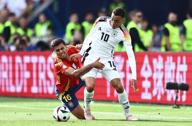 Rodri of Spain challenges Jamal Musiala of Germany Spain v Germany, UEFA European Championship, EM, Europameisterschaft 2024, Quarter Final, Football, Stuttgart Arena, Stuttgart, Germany, 05 Jul 2024 EDITORIAL USE ONLY No use with unauthorised audio, video, data, fixture lists, club league logos or live services. Online in-match use limited to 120 images, no video emulation. No use in betting, games or single club league player publications.  Copyright: xMichaelxZemanek Shutterstockx 14571380bf