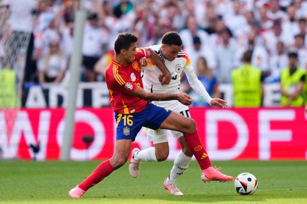 Spain v Germany: Quarter-Final - UEFA EURO, EM, Europameisterschaft,Fussball 2024 Jamal Musiala attacking midfield of Germany and Bayern Munich and Rodrigo Hernandez defensive midfield of Spain and Manchester City compete for the ball during the UEFA EURO 2024 quarter-final match between Spain and Germany at Stuttgart Arena on July 5, 2024 in Stuttgart, Germany. Stuttgart Germany  Copyright: xJosexBretonx originalFilename:bretonhernandez-spainvge240705_npZKV.jpg