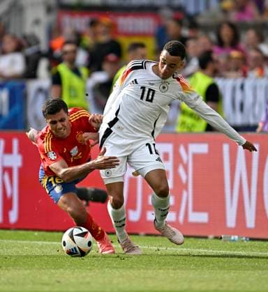 05.07.2024, Fussball UEFA EURO, EM, Europameisterschaft,Fussball 2024, Viertelfinale, Spanien - Deutschland, in der Stuttgart-Arena. v.l. Rodri (Spanien) mit vollem Einsatz gegen Jamal Musiala (Deutschland)