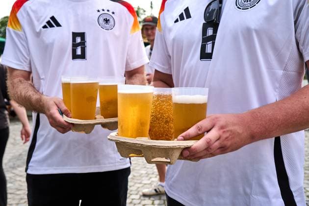 Munich, Bavaria, Germany - July 5, 2024: Public viewing in the fan zone in Munich s Olympiapark for the quarter-final of UEFA EURO, EM, Europameisterschaft,Fussball 2024 Germany vs. Spain. German fans with several cups of beer