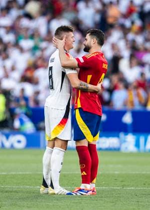 Stuttgart, MHPArena 05.07.2024: Nacho of spain comforts Toni Kroos of germany during the quarterfinal match Spain v. Germany at the UEFA European Championship, EM, Europameisterschaft 2024.