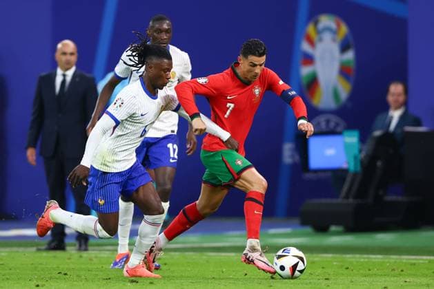 Cristiano Ronaldo of Portugal and Eduardo Camavinga of France Portugal v France, UEFA European Championship, EM, Europameisterschaft 2024, Quarter Final, Football, Volksparkstadion, Hamburg, Germany, 05 Jul 2024 EDITORIAL USE ONLY No use with unauthorised audio, video, data, fixture lists, club league logos or live services. Online in-match use limited to 120 images, no video emulation. No use in betting, games or single club league player publications. Copyright: xKieranxMcManus Shutterstockx 14571382ax