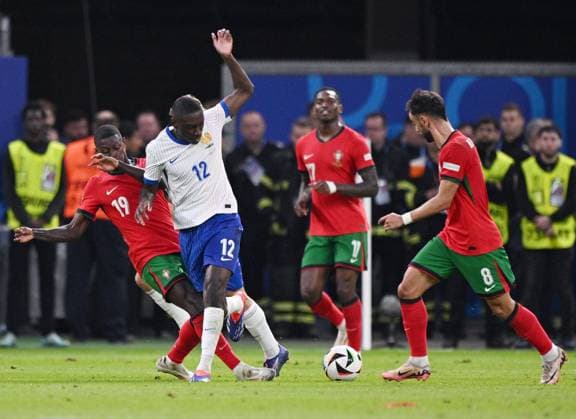 Russia Soccer Euro 2024 Portugal - France 8723184 05.07.2024 Portugal s Nuno Mendes, France s Randal Kolo Muani and Portugal s Bruno Fernandes struggle for the ball during the UEFA EURO, EM, Europameisterschaft,Fussball 2024 quarter final soccer match between Portugal and France at the Volksparkstadion in Hamburg, Germany. Alexey Filippov Sputnik Hamburg Germany  Copyright: xAlexeyxFilippovx
