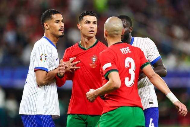Portugal v France 5 July 2024, Hamburg - UEFA EUROs - Quarter-Final - Portugal v France - William Saliba of France holds onto Cristiano Ronaldo of Portugal - Photo: Charlotte Wilson Offside. Hamburg Germany Copyright: xCharlottexWilsonx xOffsidexOffside