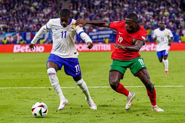 2024-07-05 Portugal v France - Quarter-Final - UEFA EURO, EM, Europameisterschaft,Fussball 2024 HAMBURG, GERMANY - JULY 5: Ousmane Dembele of France, Nuno Mendes of Portugal battle for the ball during the Quarter-Final - UEFA EURO 2024 match between Portugal and France at Volksparkstadion on July 5, 2024 in Hamburg, Germany. (Photo by Joris Verwijst BSR Agency) Hamburg Germany Content not available for redistribution in The Netherlands directly or indirectly through any third parties. Copyright: xBSRxAgencyx