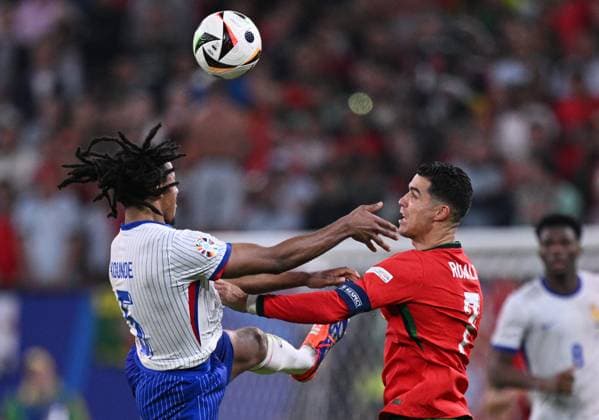 Russia Soccer Euro 2024 Portugal - France 8723250 05.07.2024 France s Jules Kounde and Portugal s Cristiano Ronaldo struggle for the ball during the UEFA EURO, EM, Europameisterschaft,Fussball 2024 quarter final soccer match between Portugal and France at the Volksparkstadion in Hamburg, Germany. Alexey Filippov Sputnik Hamburg Germany  Copyright: xAlexeyxFilippovx