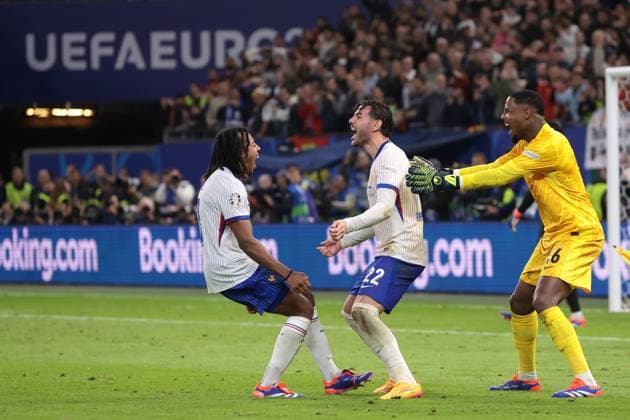 Hamburg, Germany, 5th July 2024. Theo Hernandez of France celebrates with team mates Jules Kounde and Mike Maignan after scoring the decisive spot kick in the penalty shoot out during the UEFA European Championships quarter final match at Volksparkstadion, Hamburg. Picture credit should read: Jonathan Moscrop Sportimage EDITORIAL USE ONLY. No use with unauthorised audio, video, data, fixture lists, club league logos or live services. Online in-match use limited to 120 images, no video emulation. No use in betting, games or single club league player publications. SPI-3219-0025
