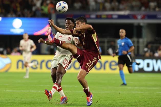 Venezuela s defender Nahuel Ferraresi (R) vies for the ball with Canada™s forward Jonathan David during the Copa America USA 2024 quarterfinal match between Venezuela and Canada, at AT&T stadium in Arlington, TX, on July 5, 2024. ARLINGTON UNITED STATES Copyright: xALEJANDROxPAGNIx