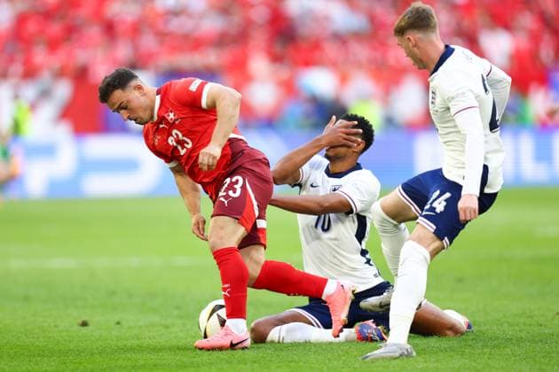 England v Switzerland 6 July 2024, Dusseldorf - UEFA EUROs - Quarter-Final - England v Switzerland - Jude Bellingham of England goes down holding his face as Xherdan Shaqiri of Switzerland - Photo: Charlotte Wilson Offside. Dusseldorf Germany Copyright: xCharlottexWilsonx xOffsidexOffside