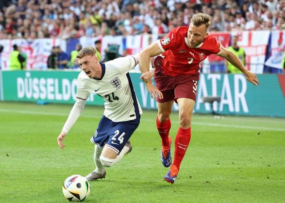 Dusseldorf, Germany, 6th July 2024. Cole Palmer of England and Silvan Widmer of Switzerland during the UEFA European Championships Quarter Final match at Dusseldorf Arena, Dusseldorf. Picture credit should read: Paul Terry Sportimage EDITORIAL USE ONLY. No use with unauthorised audio, video, data, fixture lists, club league logos or live services. Online in-match use limited to 120 images, no video emulation. No use in betting, games or single club league player publications. SPI-3218-0221