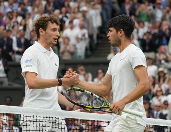 Lawn Tennis - 2024 Wimbledon Championship Mens Singles - Carlos Alcaraz (ESP) v Ugo Humbert (FRA) All England Lawn Tennis & Croquet Club - Sunday 7th July 2024 Carlos Alcaraz (ESP) at the net after the match with Ugo Humbert 