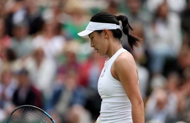 (240708) -- LONDON, July 8, 2024 -- Wang Xinyu of China reacts during the women s singles 4th round match between Elina Svitolina of Ukraine and Wang Xinyu of China at Wimbledon tennis Championship in London, Britain, on July 8, 2024. ) (SP)BRITAIN-LONDON-TENNIS-WIMBLEDON-DAY 8 LixYing 