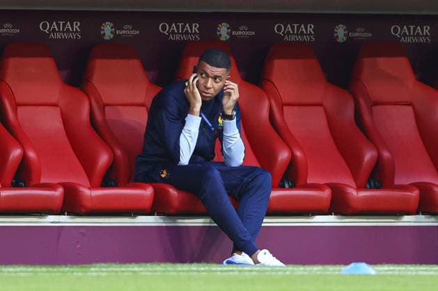 Kylian MbappÃ of France sits on their phone in the dugout during the arrivals Spain v France, UEFA European Championship, EM, Europameisterschaft 2024, Semi Final, Football, Munich Football Arena, Munich, Germany - 09 Jul 2024 EDITORIAL USE ONLY No use with unauthorised audio, video, data, fixture lists, club league logos or live services. Online in-match use limited to 120 images, no video emulation. No use in betting, games or single club league player publications.  Copyright: xKieranxMcManus Shutterstockx 14576874j