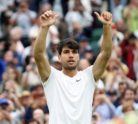 Spain s Carlos Alcaraz waves to the crowd after victory in his Men s Quarter-Final match against USA s Tommy Paul at the 2024 Wimbledon Championships in London on Tuesday, July 09, 2024.  LON2024070950 HUGOxPHILPOTT