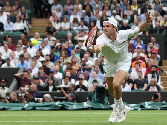 USA s Tommy Paul plays a backhand in his Men s Quarter-Final match against Spain s Carlos Alcaraz at the 2024 Wimbledon Championships in London on Tuesday, July 09, 2024.  LON2024070958 HUGOxPHILPOTT