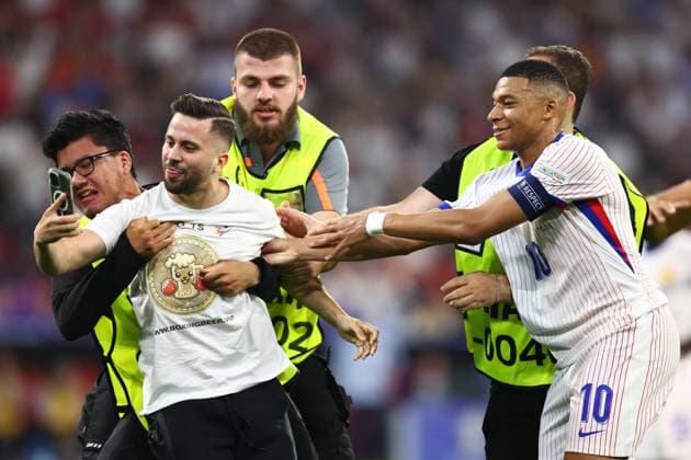 Spain v France 9 July 2024, Munich - UEFA EUROs - Semi-Final - Spain v France - A pitch invader tries to take a photo with Kylian Mbappe of France - Photo: Charlotte Wilson Offside. Munich Germany Copyright: xCharlottexWilsonx xOffsidexOffside