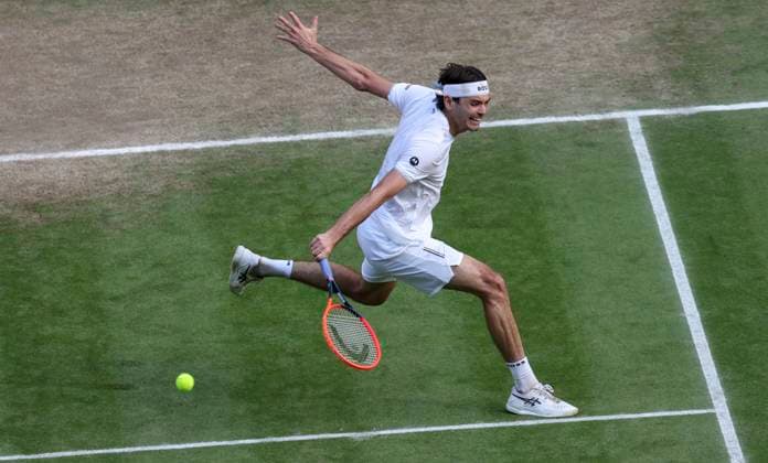 (240711) -- LONDON, July 11, 2024 -- Taylor Fritz of the United States hits a return during the men s singles quarterfinal between Lorenzo Musetti of Italy and Taylor Fritz of the United States at Wimbledon tennis Championship in London, Britain, on July 10, 2024. ) (SP)BRITAIN-LONDON-TENNIS-WIMBLEDON-DAY 10 HanxYan 