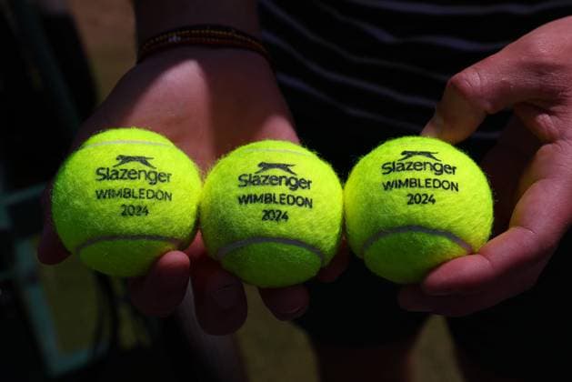 11th July 2024; All England Lawn Tennis and Croquet Club, London, England; Wimbledon Tennis Tournament, Day 11; Wimbledon Championship staff holds three 2024 Wimbledon Championship tennis balls  ActionPlus12666939 JohnxPatrickxFletcher