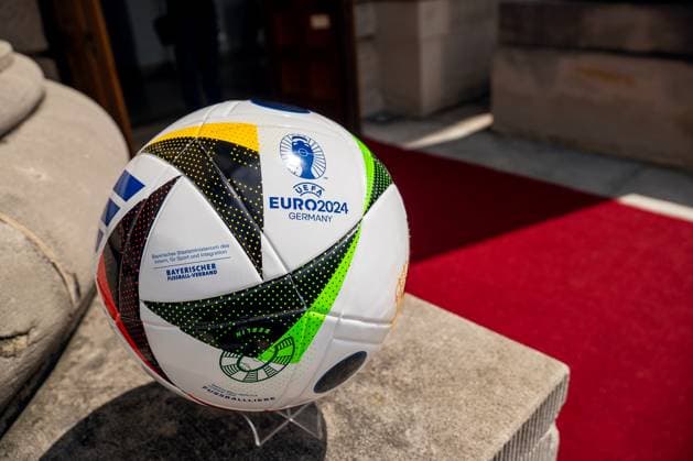 Munich, Bavaria, Germany - 11 July 2024: Honoring the volunteers of the UEFA EURO, EM, Europameisterschaft,Fussball 2024 European Football Championship in the Unterer Hofgarten in Munich. An official UEFA EURO 2024 match ball, presented in front of a red carpet with the logo of the Bavarian Football Association