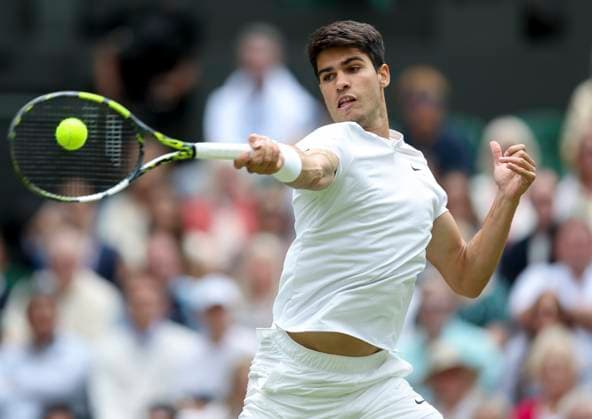 (240712) -- LONDON, July 12, 2024 -- Carlos Alcaraz of Spain hits a return during the men s singles semifinal between Daniil Medvedev of Russia and Carlos Alcaraz of Spain at Wimbledon tennis Championship in London, Britain, on July 12, 2024. ) (SP)BRITAIN-LONDON-TENNIS-WIMBLEDON--MEN S SINGLES-SEMIFINALS HanxYan 