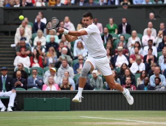 Novak Djokovic plays a backhand in his Men s Semi-Final match against Lorenzo Musetti at the 2024 Wimbledon Championships in London on Friday, July 12, 2024.  LON2024071236 HUGOxPHILPOTT