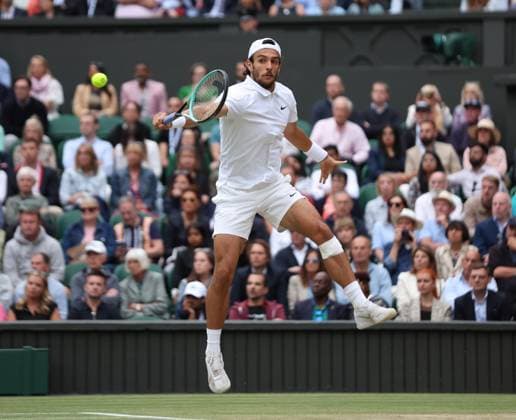 Lorenzo Musetti plays a backhand in his Men s Semi-Final match against Novak Djokovic at the 2024 Wimbledon Championships in London on Friday, July 12, 2024.  LON2024071245 HUGOxPHILPOTT