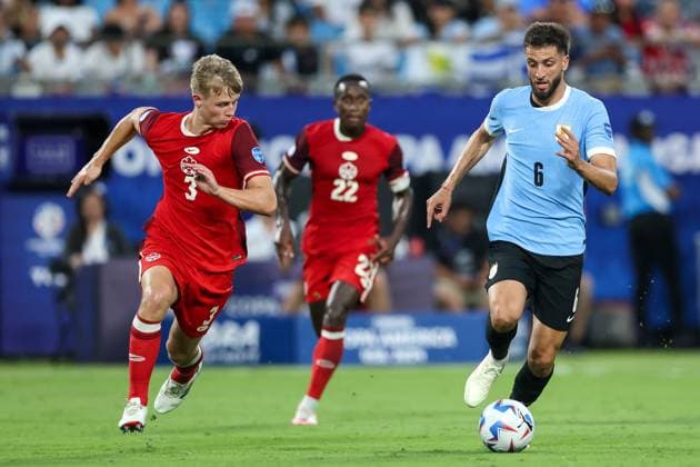 July 13, 2024, Charlotte, North Carolina, U.S: Uruguay midfielder RODRIGO BENTANCUR (6) drives the ball away from Canada defender LUC DE FOUGEROLLES (3) during the first half of the CONMEBOL Copa America match between Uruguay and Canada at Bank of America Stadium in Charlotte, NC on July 13, 2024. Charlotte U.S - ZUMAk149 20240713_zsp_k149_024 Copyright: xCoryxKnowltonx