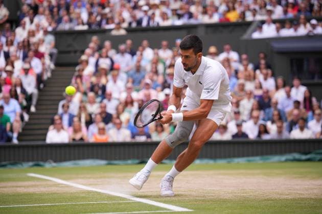LONDON, ENGLAND - JULY 14: Novak Djokovic of Serbia plays a backhand against Carlos Alcaraz of Spain in the Gentlemen s Singles Final during day fourteen of The Championships Wimbledon 2024 at All England Lawn Tennis and Croquet Club on July 14, 2024 in London, England  Copyright: xHiroshixSatox