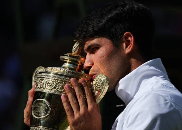 14th July 2024; All England Lawn Tennis and Croquet Club, London, England; Wimbledon Tennis Tournament, Day 14; Carlos Alcaraz (ESP) kisses the Gentlemens Singles Trophy towards the spectators on the Club House balcony after defeating Novak Djokovic (SRB) in straight sets  ActionPlus12667995 JohnxPatrickxFletcher