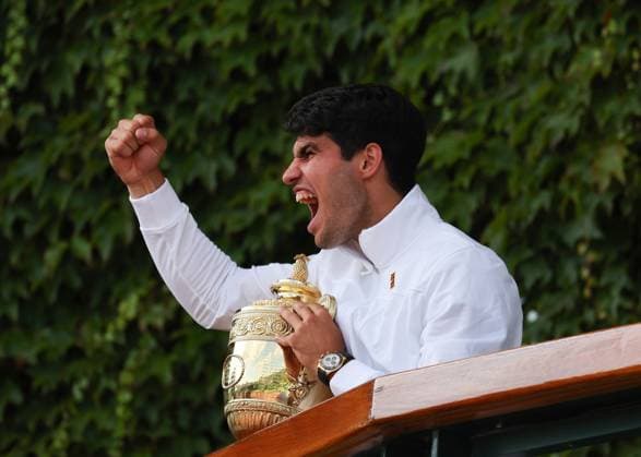 14th July 2024; All England Lawn Tennis and Croquet Club, London, England; Wimbledon Tennis Tournament, Day 14; Carlos Alcaraz (ESP) with the Gentlemens Singles Trophy on the Club House balcony celebrates towards the spectators after defeating Novak Djokovic (SRB) in straight sets  ActionPlus12668005 JohnxPatrickxFletcher