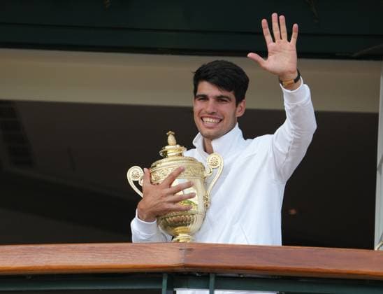Lawn Tennis - 2024 Wimbledon Championship Mens singles final Novak Djokovic (SRB) v Carlos Alcaraz (ESP) All England Lawn Tennis & Croquet Club - Sunday 14th July 2024 Carlos Alcaraz (ESP) celebrates with the crowd outside the Centre Court Balcony with the trophy 