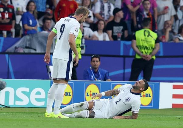 Berlin, Germany, 14th July 2024. Kyle Walker of England (R) lays injured during the UEFA European Championships final match at Olympiastadion, Berlin. Picture: Paul Terry Sportimage EDITORIAL USE ONLY. No use with unauthorised audio, video, data, fixture lists, club league logos or live services. Online in-match use limited to 120 images, no video emulation. No use in betting, games or single club league player publications. SPI-3227-0062