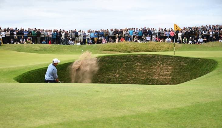 American Xander Schauffele hits out of the bunker during the second round at the 152nd Open Championship at Royal Troon Golf Club in Troon, Scotland on Friday, July 19, 2024. Tiger Woods missed the cut and finished with a score of fourteen over par.  LON2024071911 HUGOxPHILPOTT